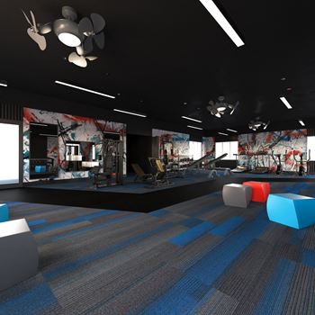 A fitness room with blue and gray carpeting and a black ceiling